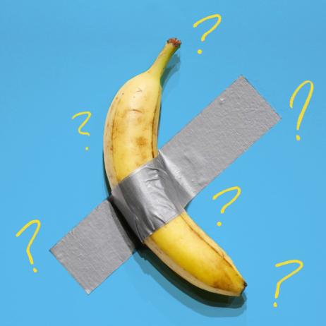 Image is of a yellow banana taped to a blue wall with grey duct tape. Drawn around the banana are 6 yellow question marks.