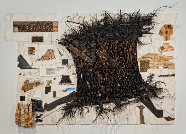 Collage of paper, wood, and found objects, creating an image of a large burnt tree stump, among similar motifs..