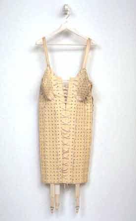 Photo of a woman's girdle made out of rubber bath mats, elastic, and ribbons.