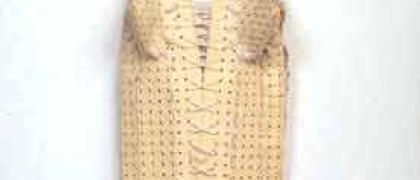 Photo of a woman's girdle made out of rubber bath mats, elastic, and ribbons.